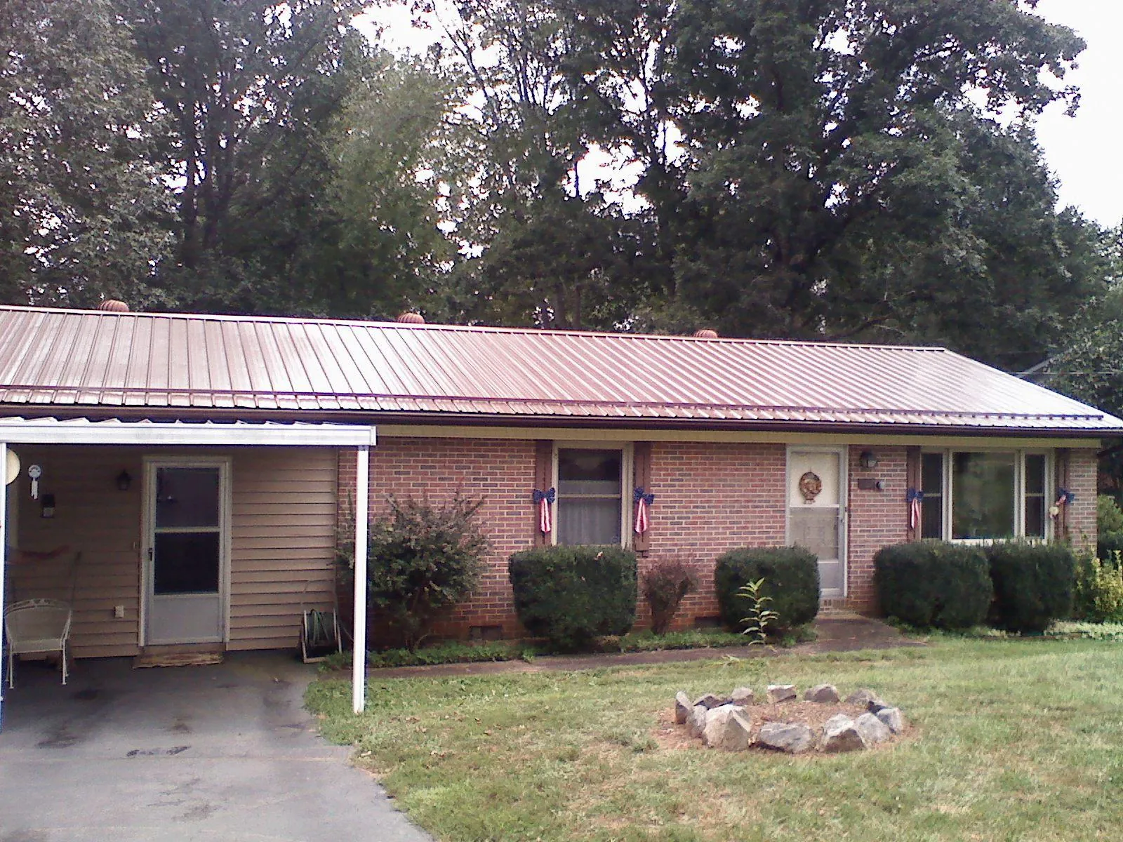 Bronze metal roof and carport on a brick ranch home — Roof Repair work by our crew in Shenandoah Junction