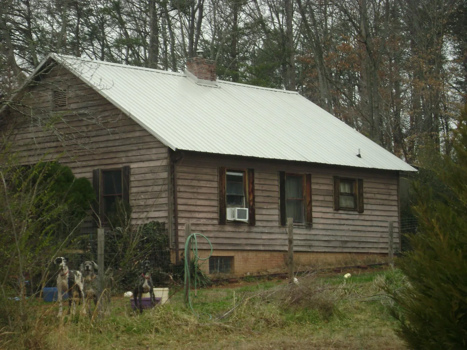 White metal roof on an old wood sided farmhouse, from a Metal Roof Installation job in Shenandoah Junction